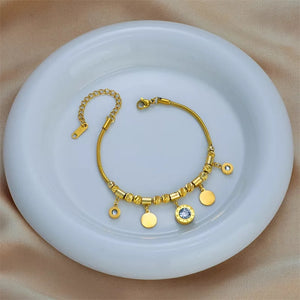 Ατσάλινο βραχιόλι, αλυσίδα με κρεμαστά στρογγυλα στοιχεία, σε κίτρινο χρυσό