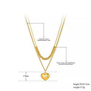 Ατσάλινο κολιέ με 2 διαφορετικές αλυσίδες και καρδιά με καρό σχέδιο, σε κίτρινο χρυσό